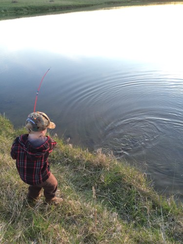 Reeling in his first fish!