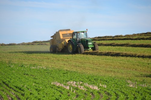 Mr. Farmer wrapping up a bale of 1st crop alfalfa.