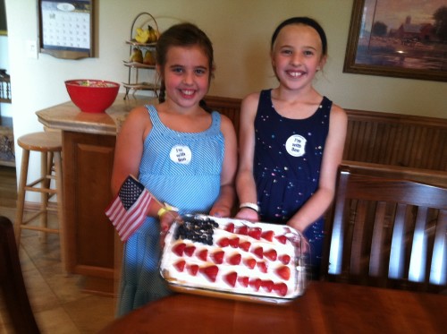 Olivia and Addie spotlighting their baking project from the day before