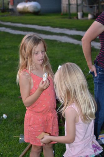 Ava and Anna eating their roasted marshmallows.