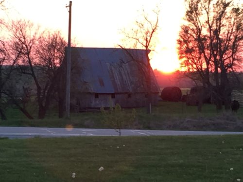 Sun setting behind the barn.
